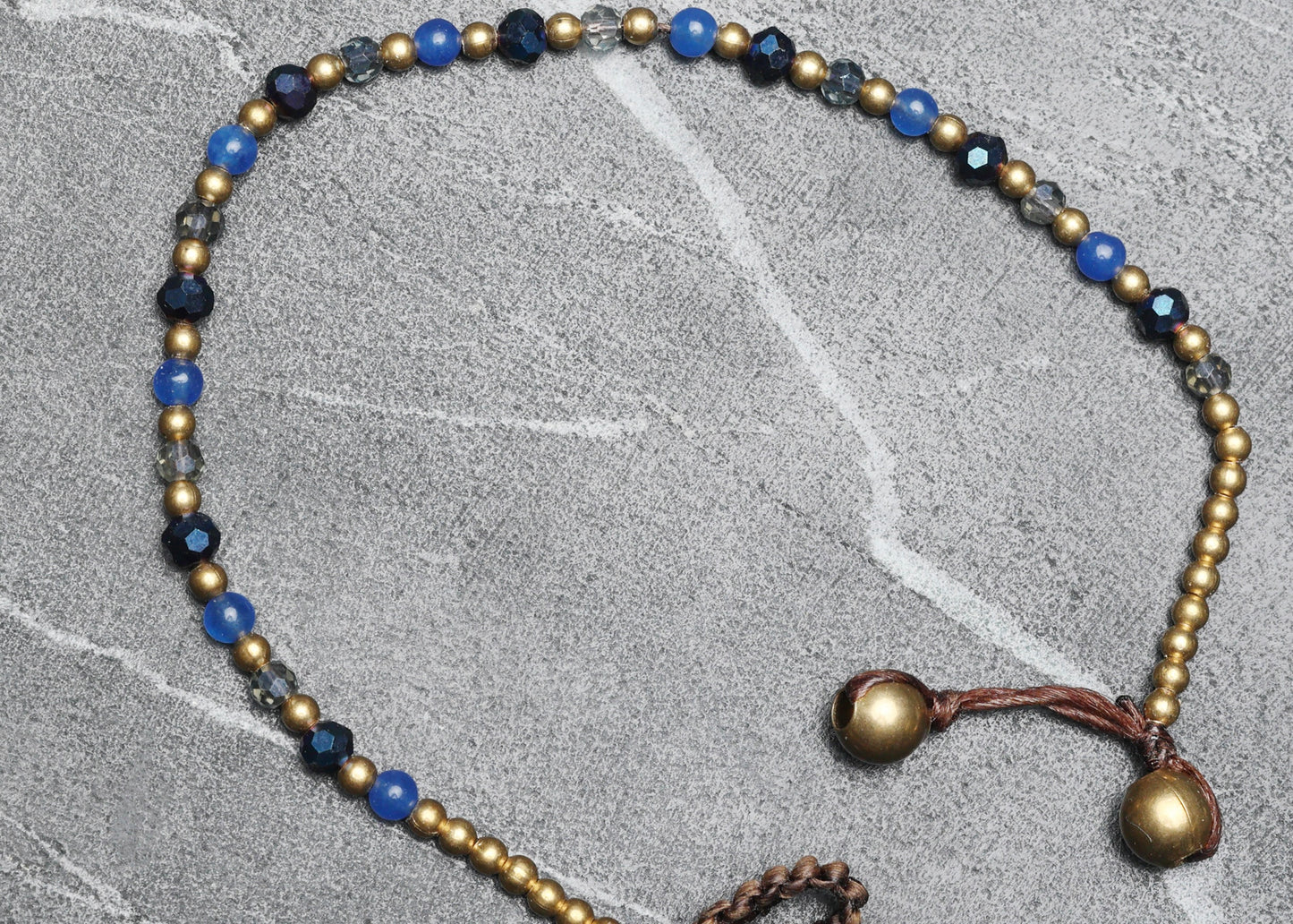 crystal healing bracelet made of faceted Blue Agate crystals on a cotton cord with brass beads